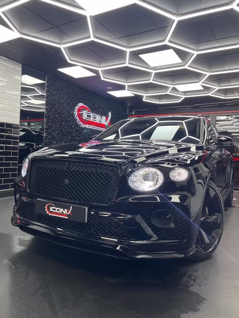 Blacked-out Bentley Bentayga with an ICONIX plate at the unit