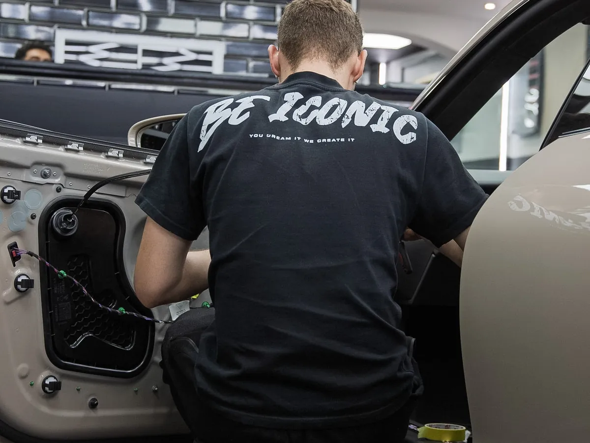 Technician working inside a door cavity in the Iconix unit