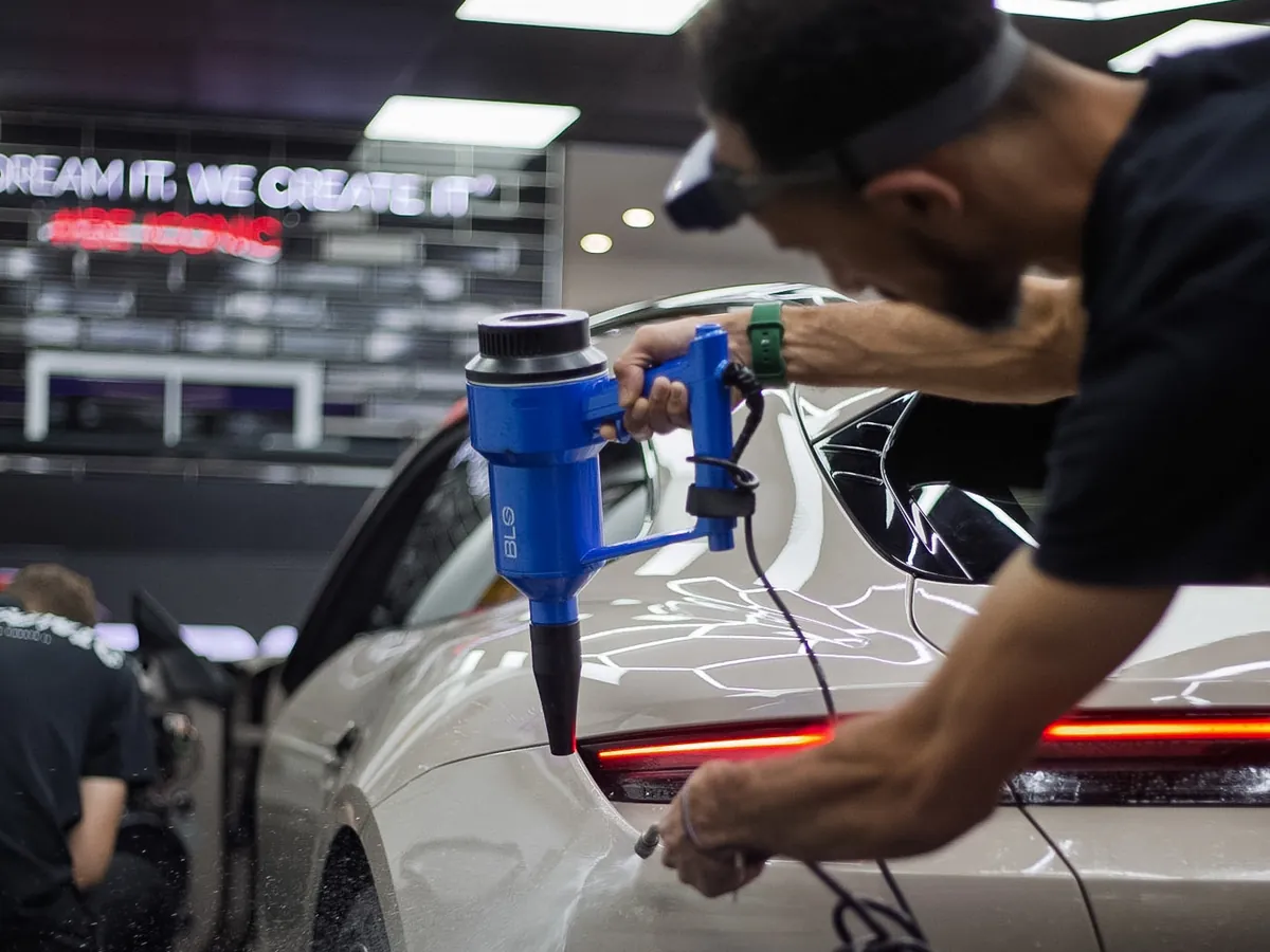 Heat gun used to lay paint protection film around the tail light of a Porsche Taycan